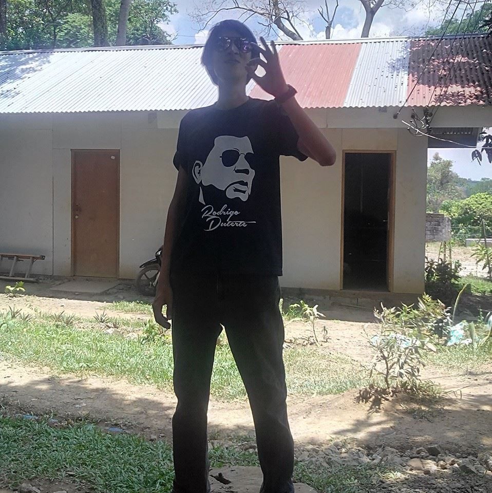 Person in black t-shirt and pants giving an