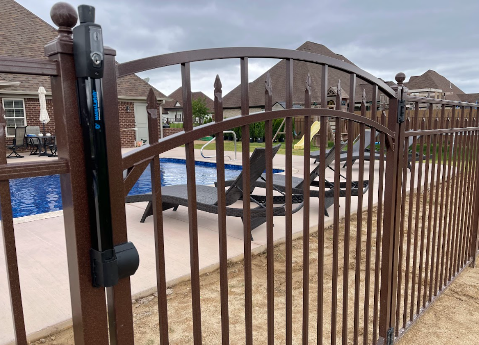 A black wrought iron fence on a white background.