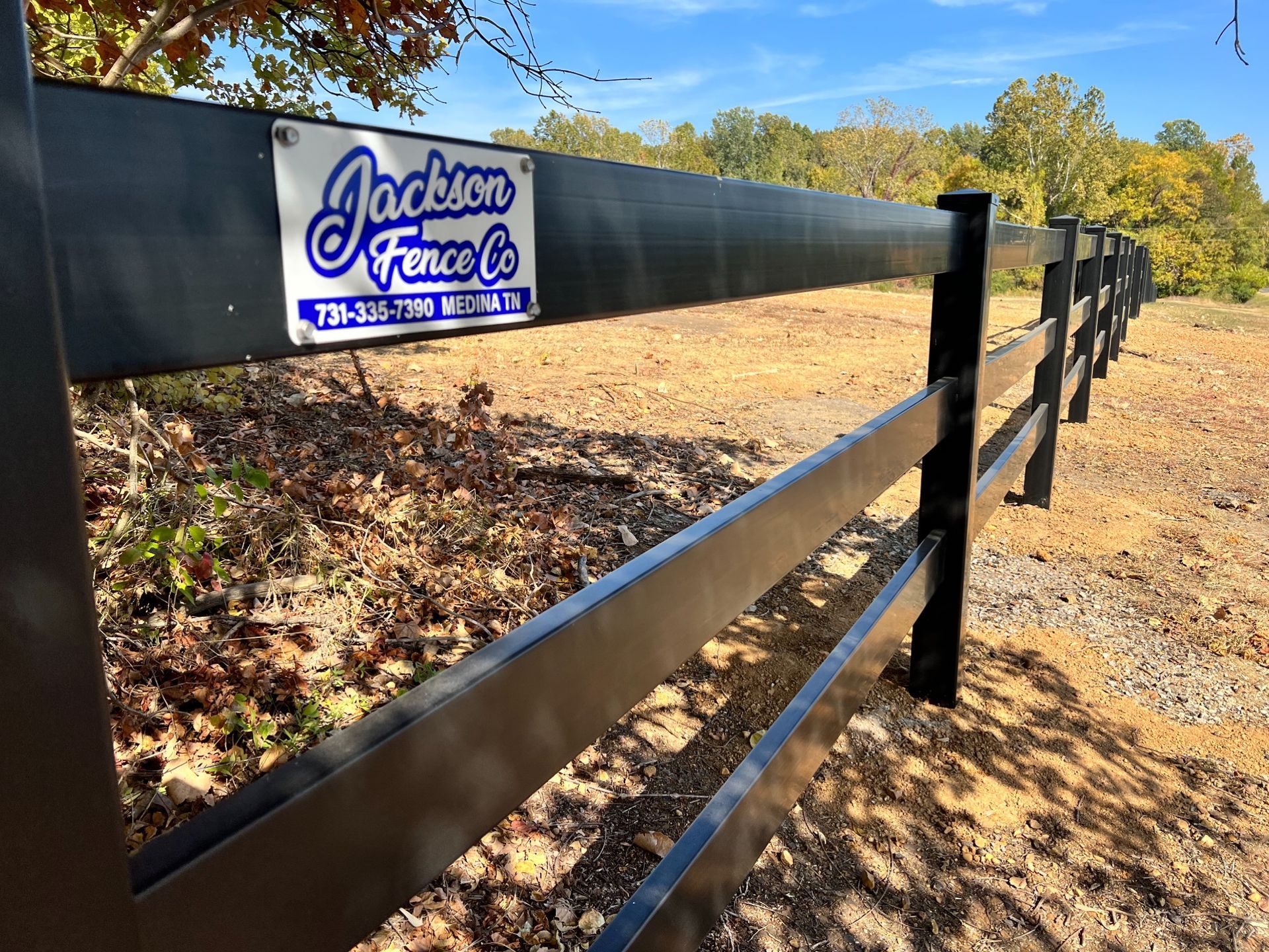 A black fence with a sign that says jackson fence co.