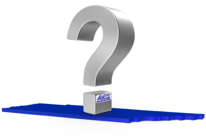 A silver question mark is sitting on top of a blue surface.