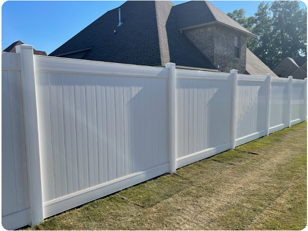 A white fence with a house in the background