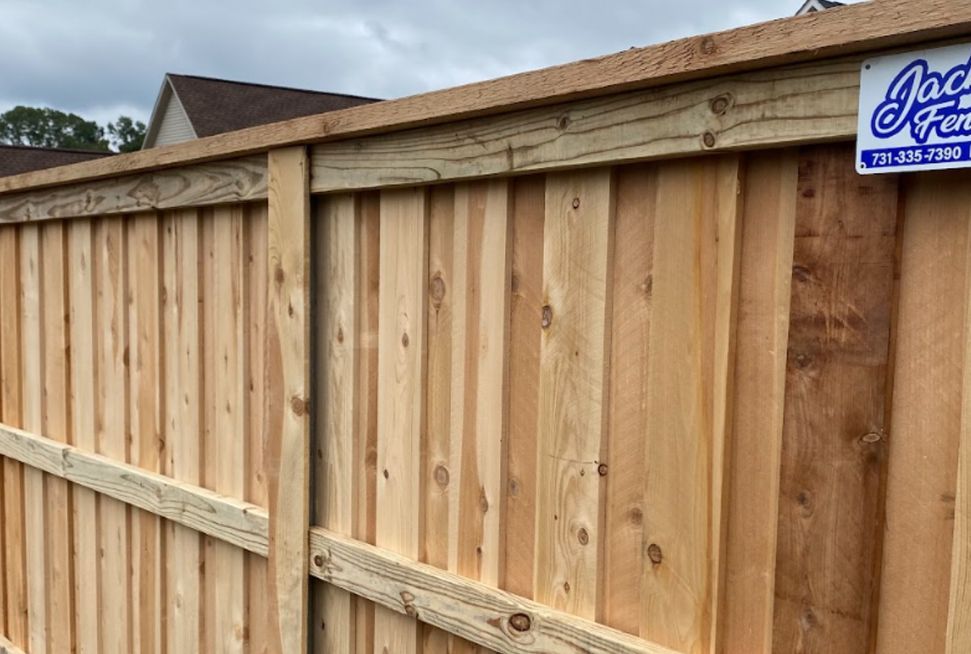 A close up of a wooden fence with a sign on it.