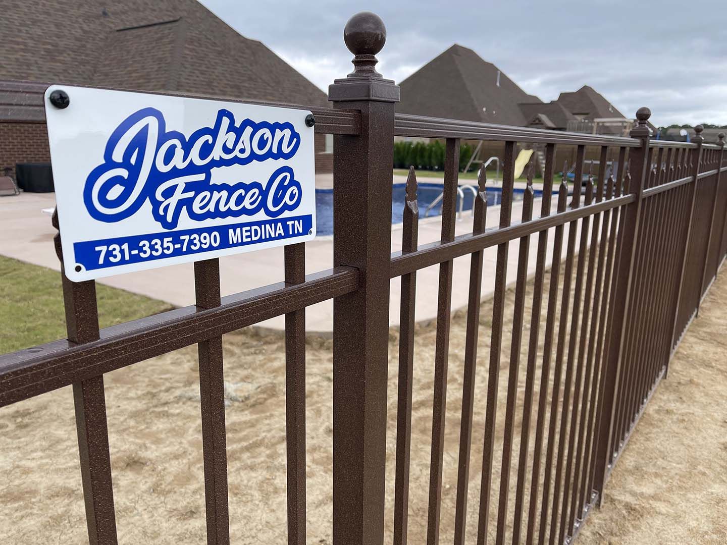 A fence with a sign that says jackson fence co