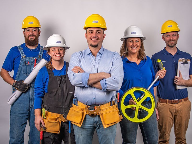 A group of construction workers are posing for a picture.
