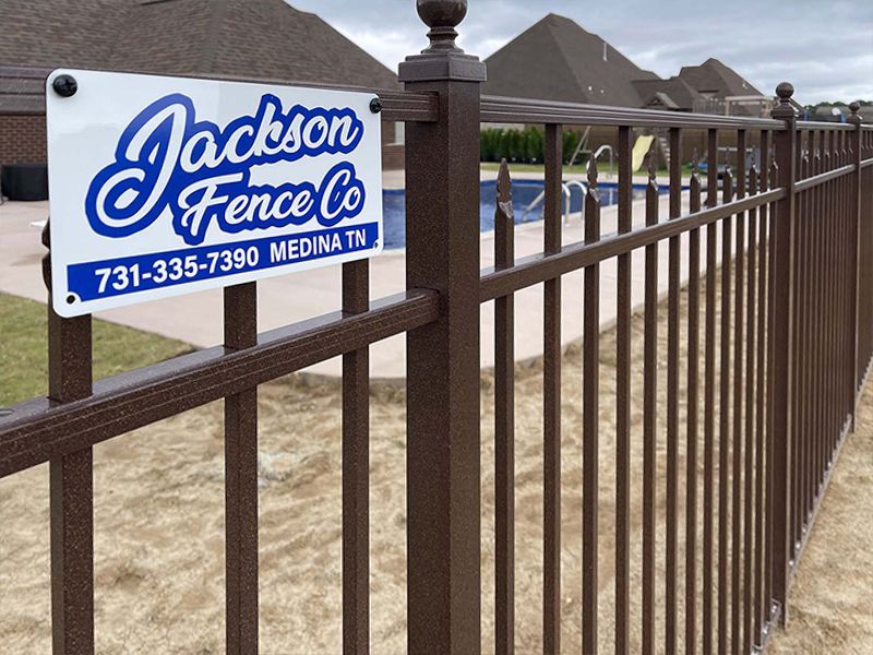 A fence with a sign that says jackson fence co