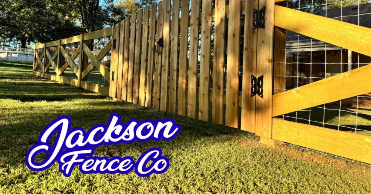 Wooden fence with a gate, green grass, and 