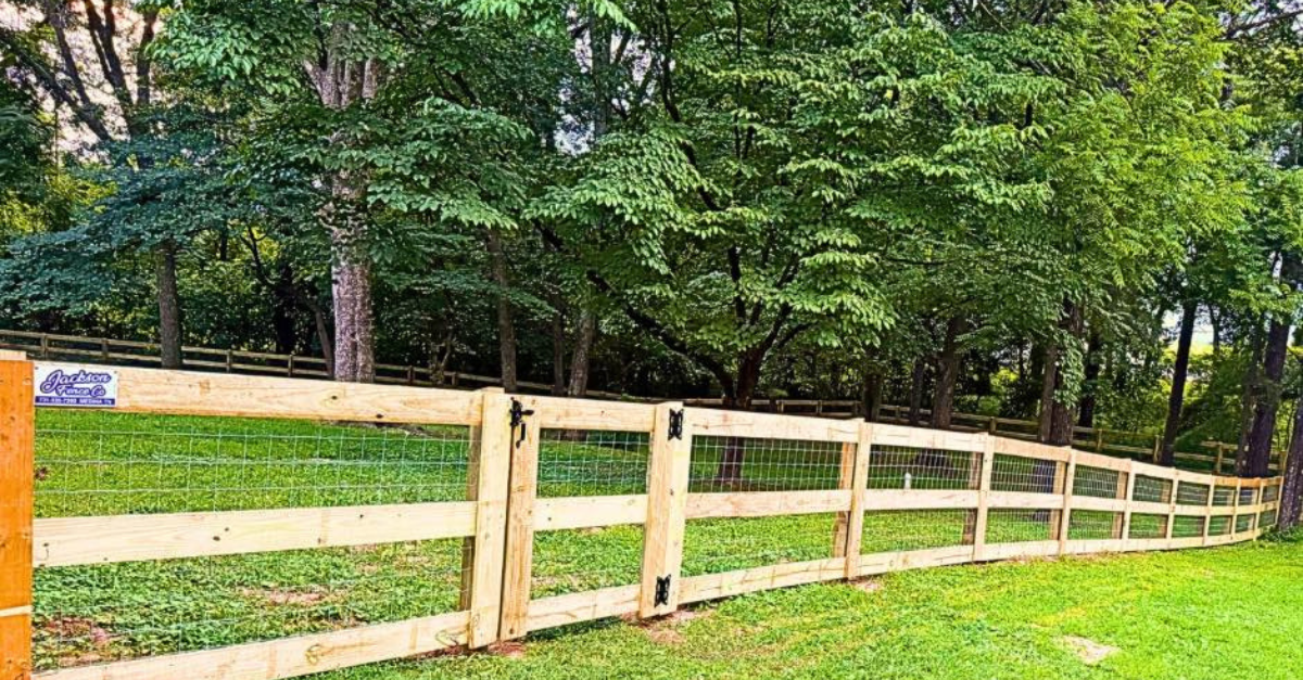 wooden post and rail fence with welded wire mesh