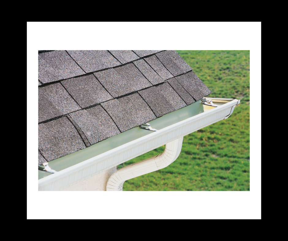 Gray roof shingles with a white gutter system.