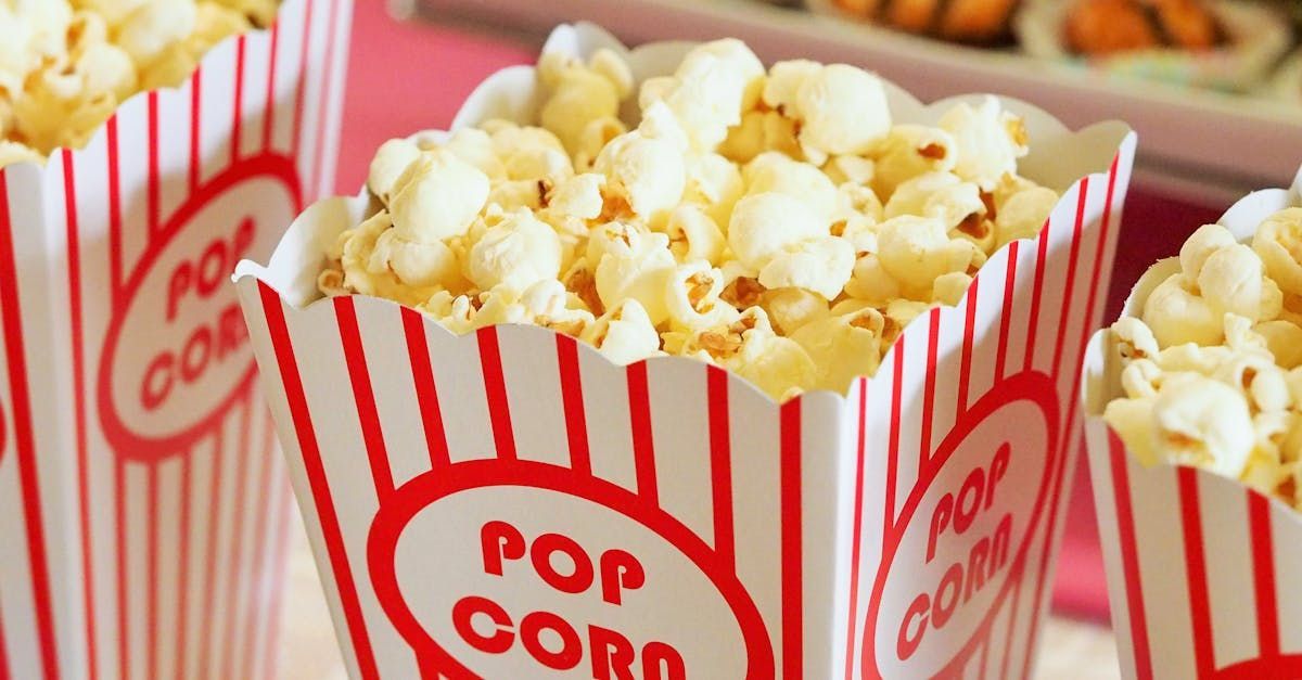 Three boxes of popcorn are sitting on a table.