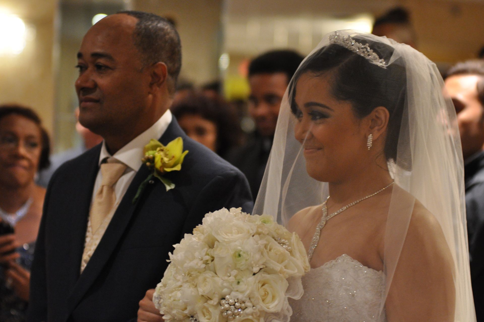 A bride is walking down the aisle with her father