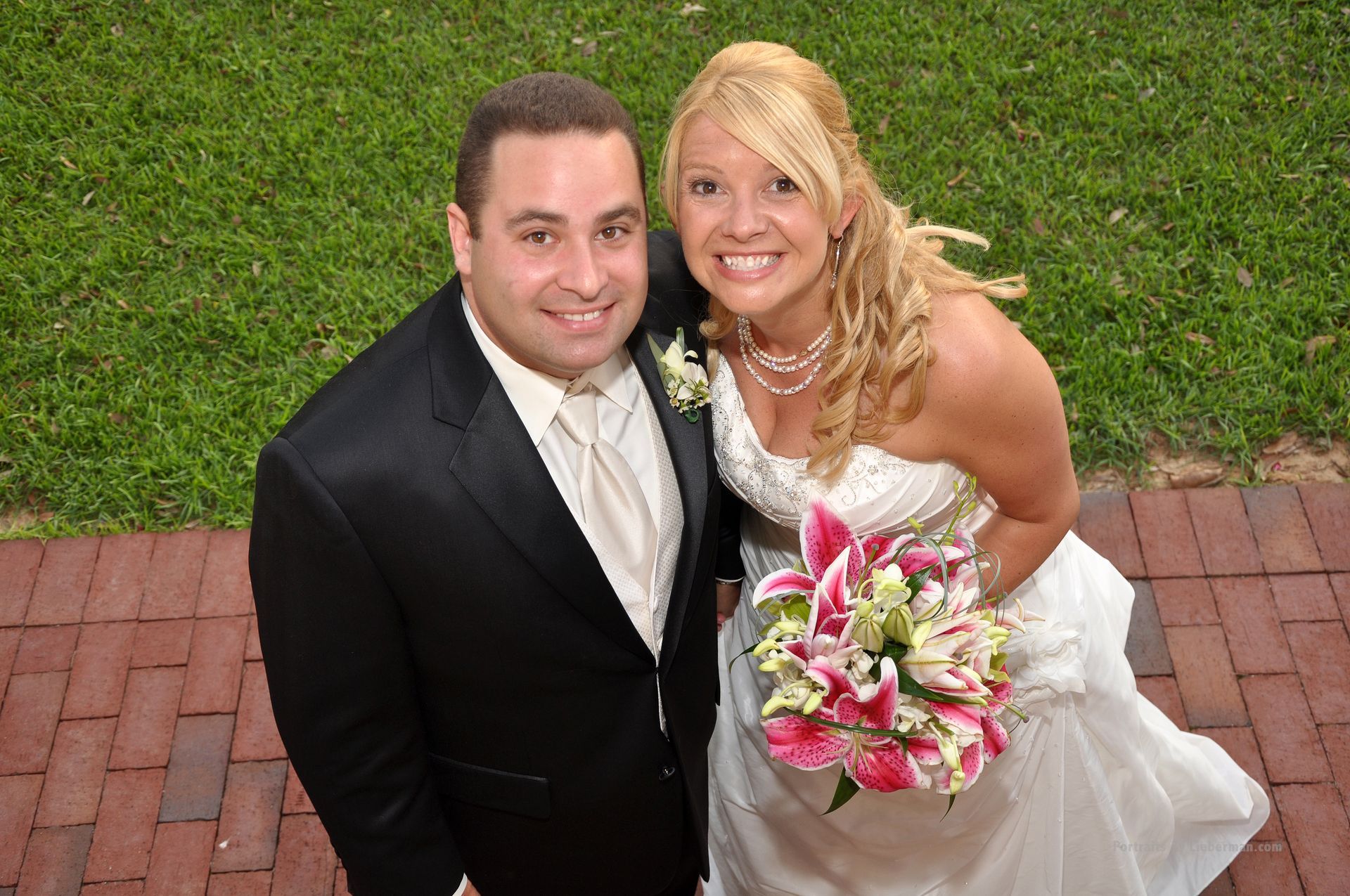A bride and groom pose for a picture on their wedding day