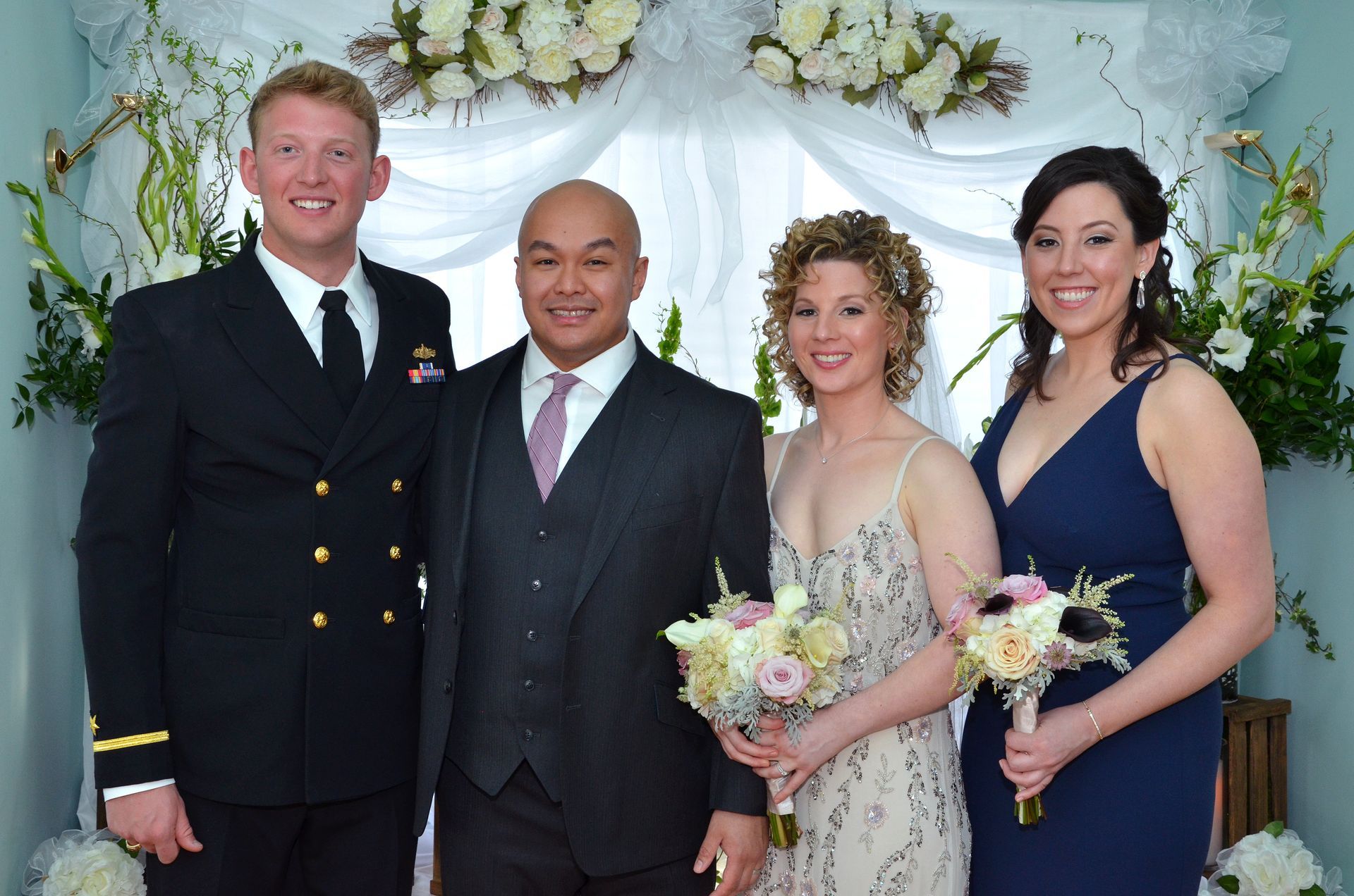 A group of people posing for a picture with flowers in the background