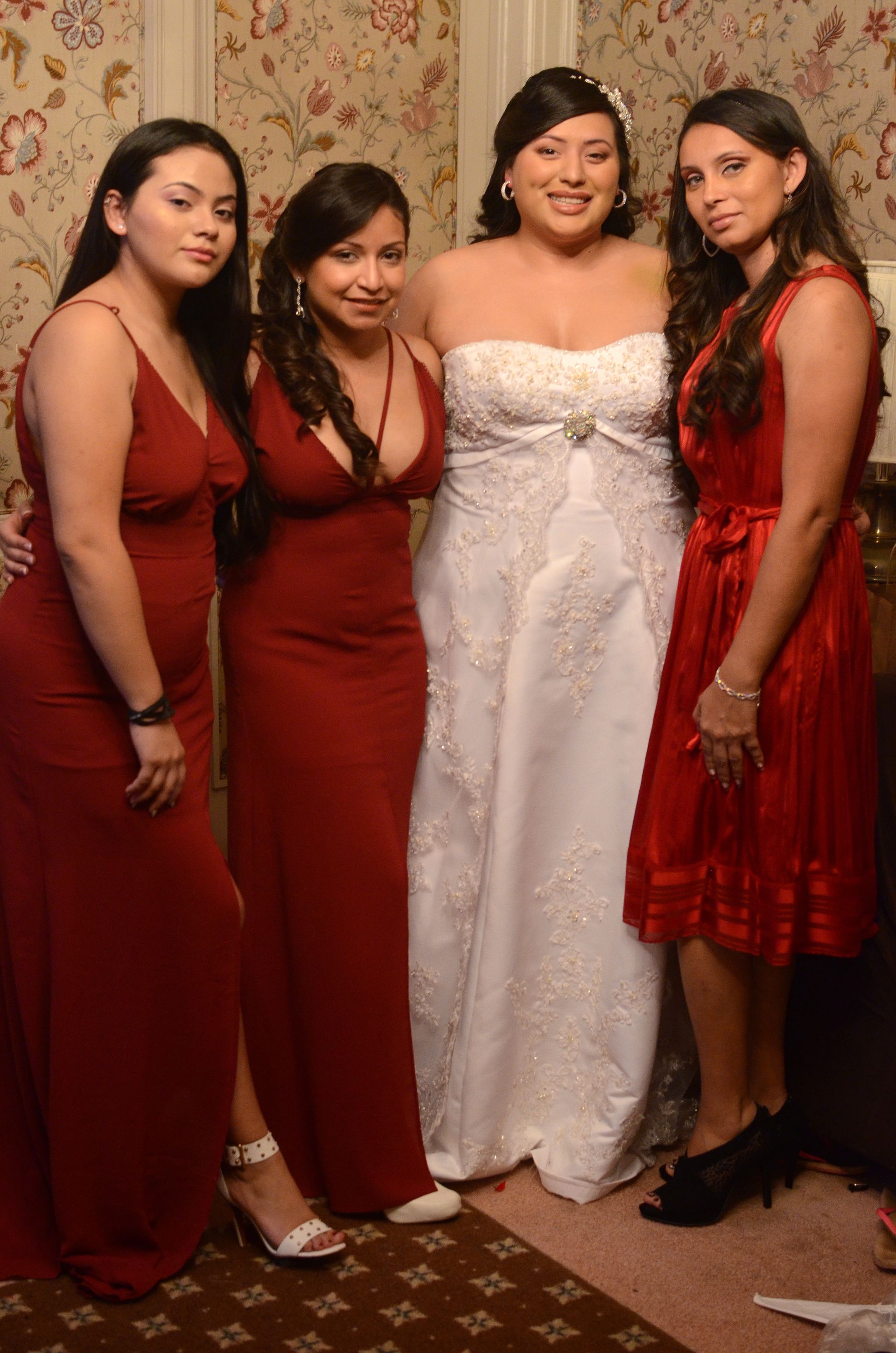 A bride and her bridesmaids are posing for a picture together.