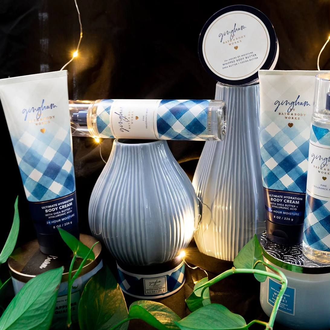 A variety of bath and body works products are displayed on a table