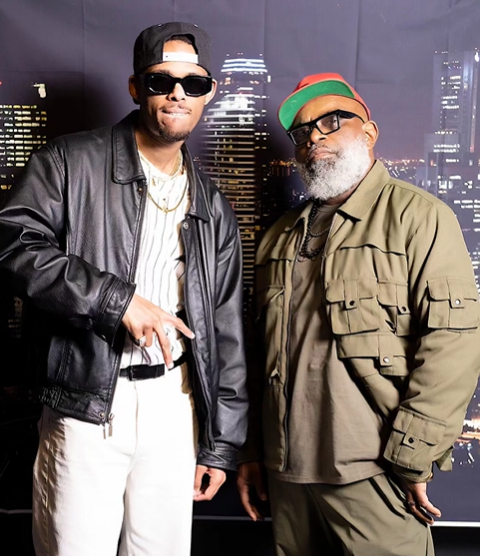 Two men standing next to each other wearing sunglasses and hats