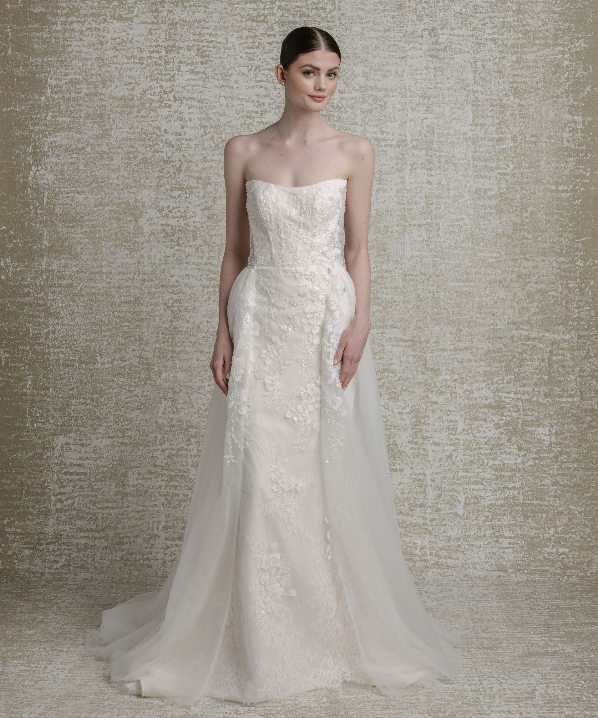 Beaded floral lace appliqué, cat-eye neckline, setachable tulle overskirt with lace appliqué