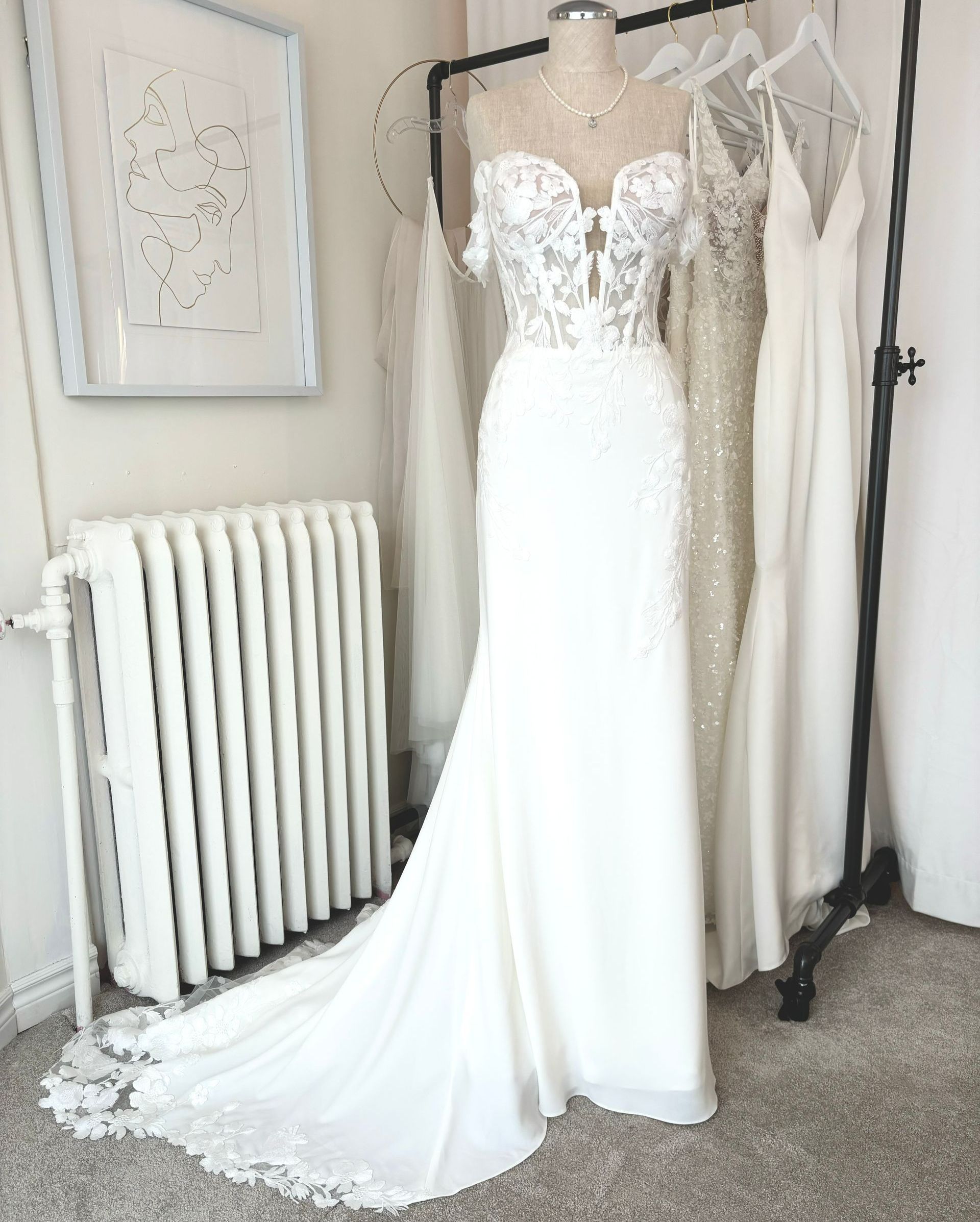 Floral illusion bodice, fitte crepe skirt. Scalloped train. Available lined.