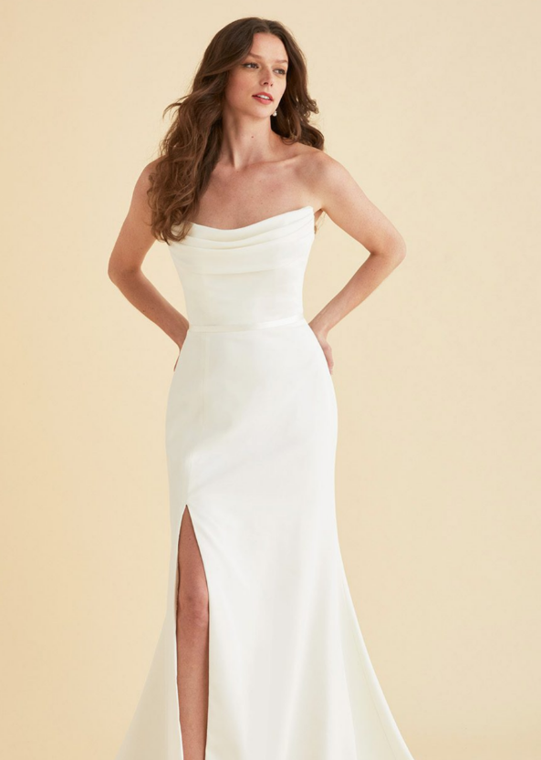 Draped, scooped neckline and flare skirt. Shown in Dove satin.