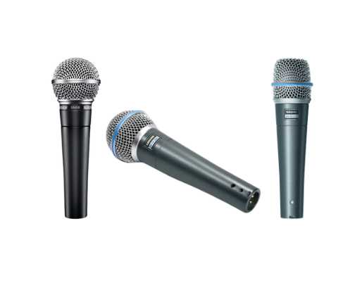 A pair of wireless microphones sitting on top of a receiver.