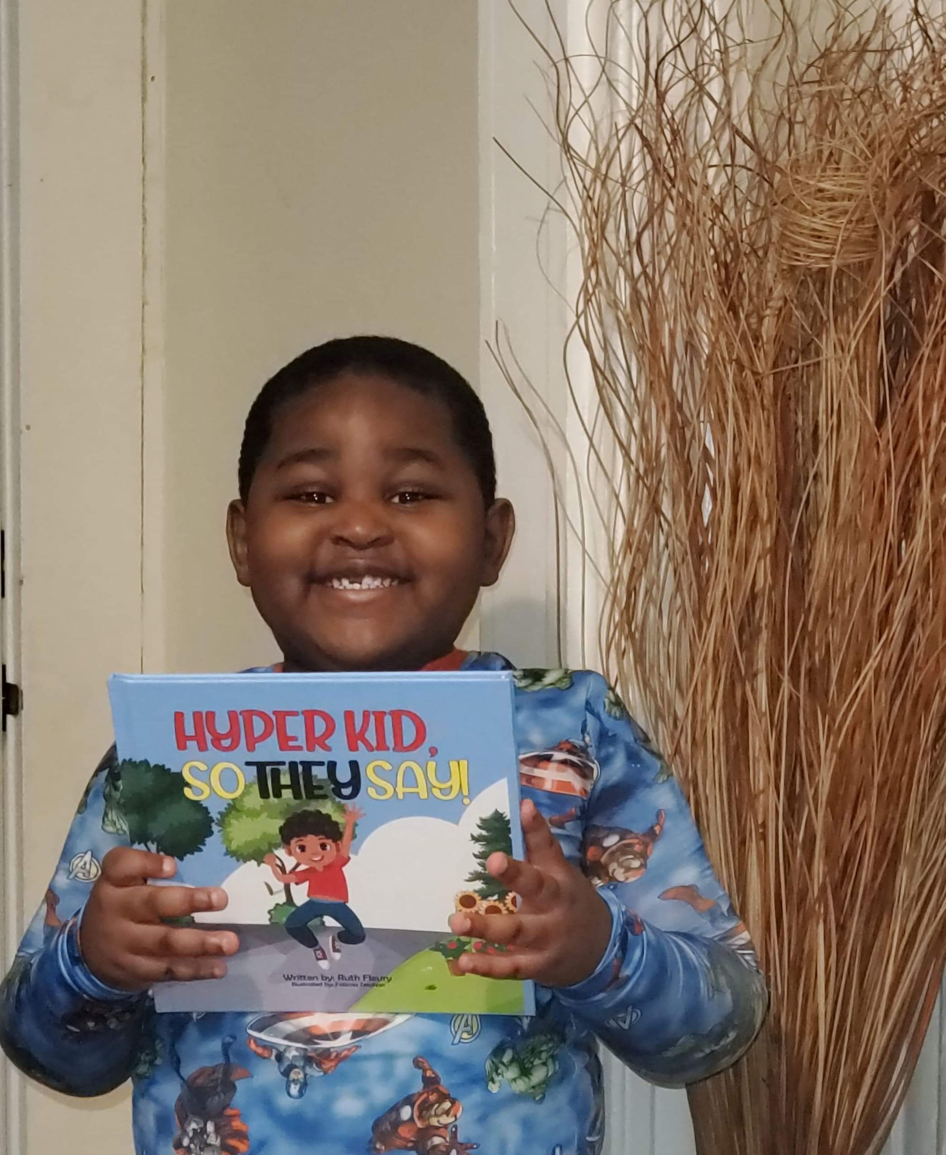Young person holding a book titled 
