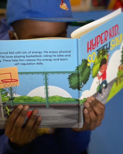 A person reading a book titled 