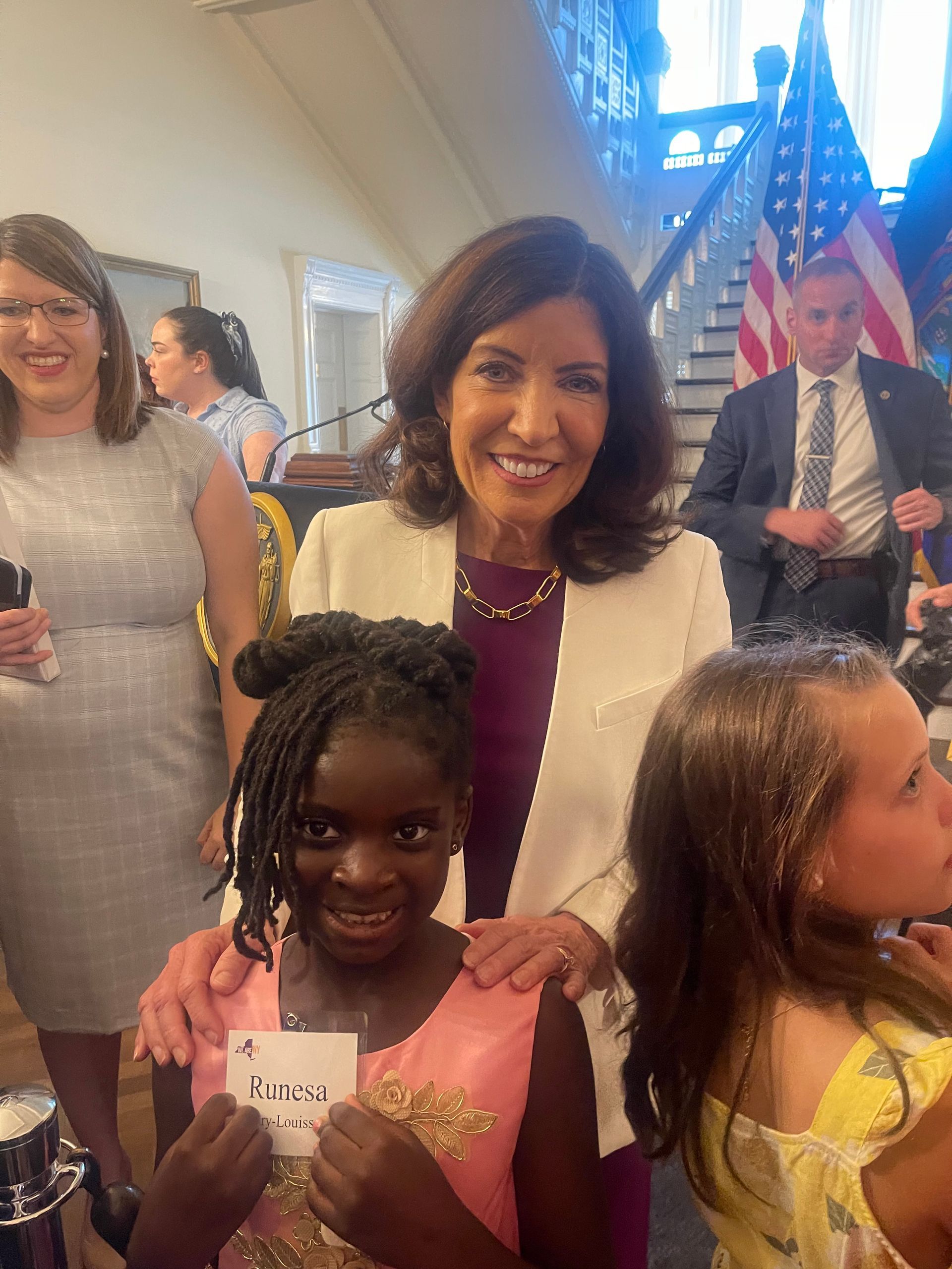 New York Governor with two children. Formal indoor setting.