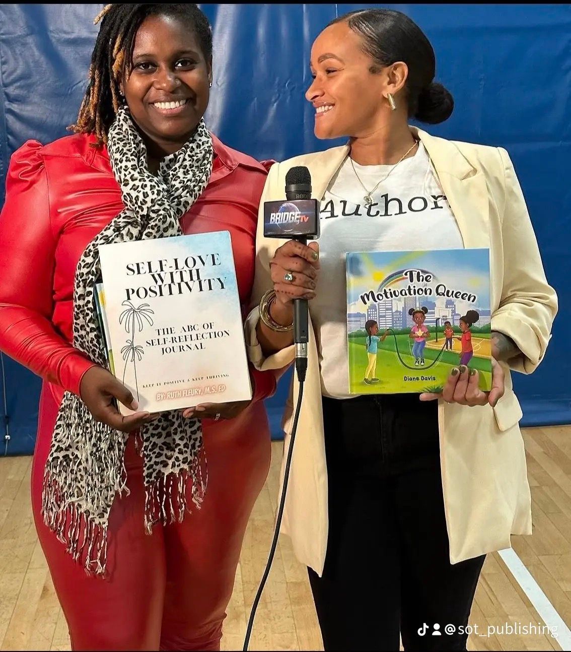 Two women holding books; one in red holding a book titled 