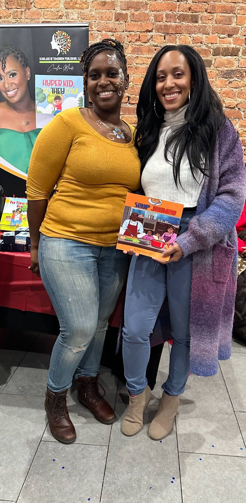 Two people pose, holding a box. 