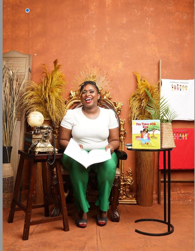 A woman is sitting in a chair reading a book.