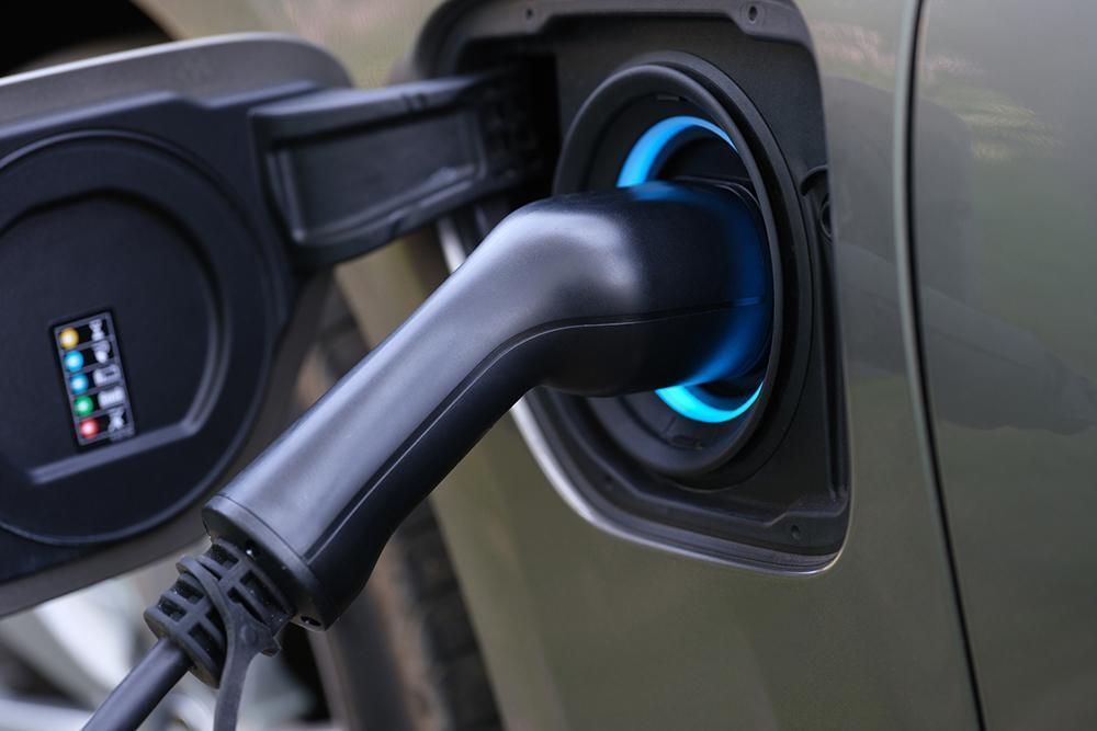 A close up of an electric car being charged.