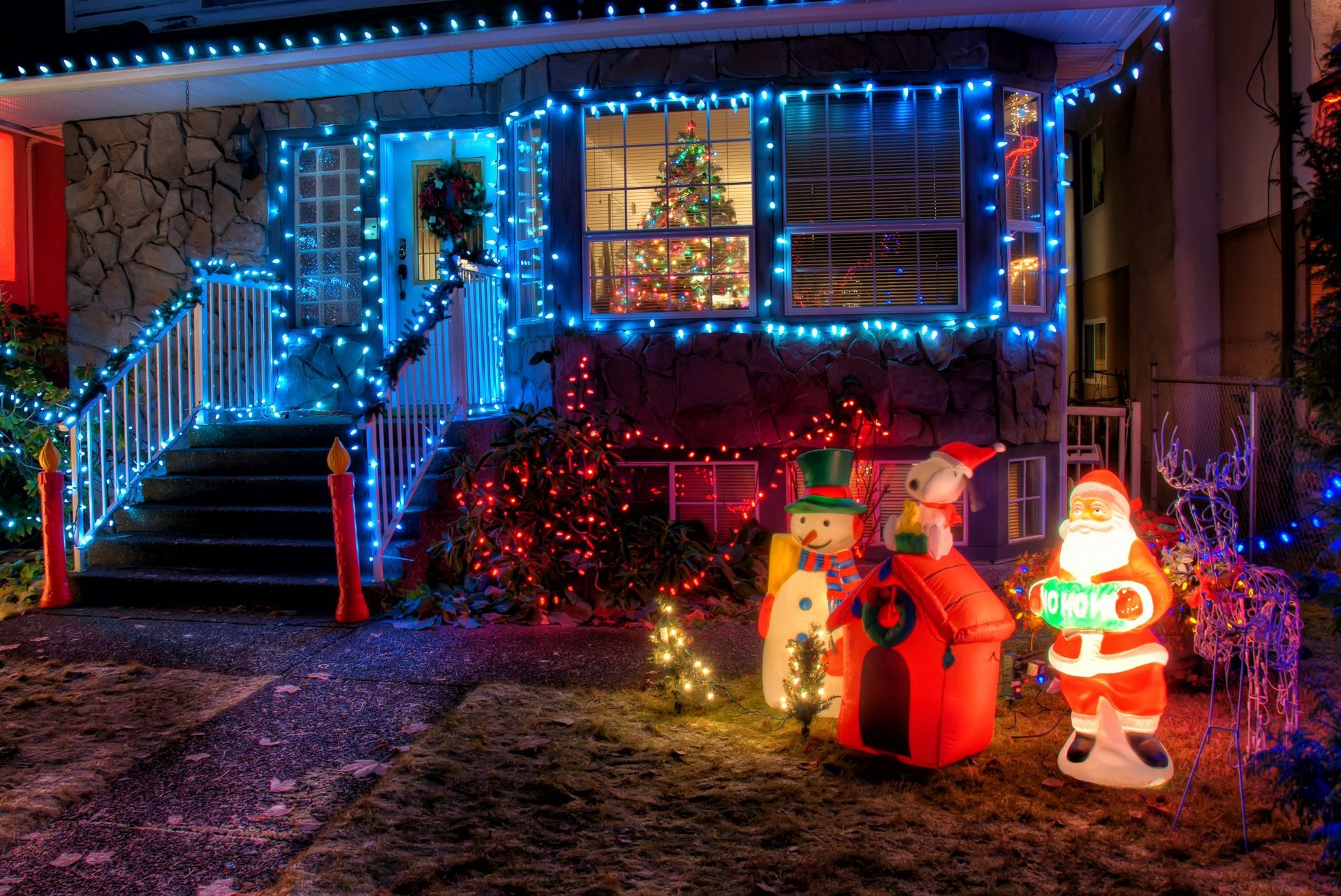 A house is decorated with Christmas lights and decorations.