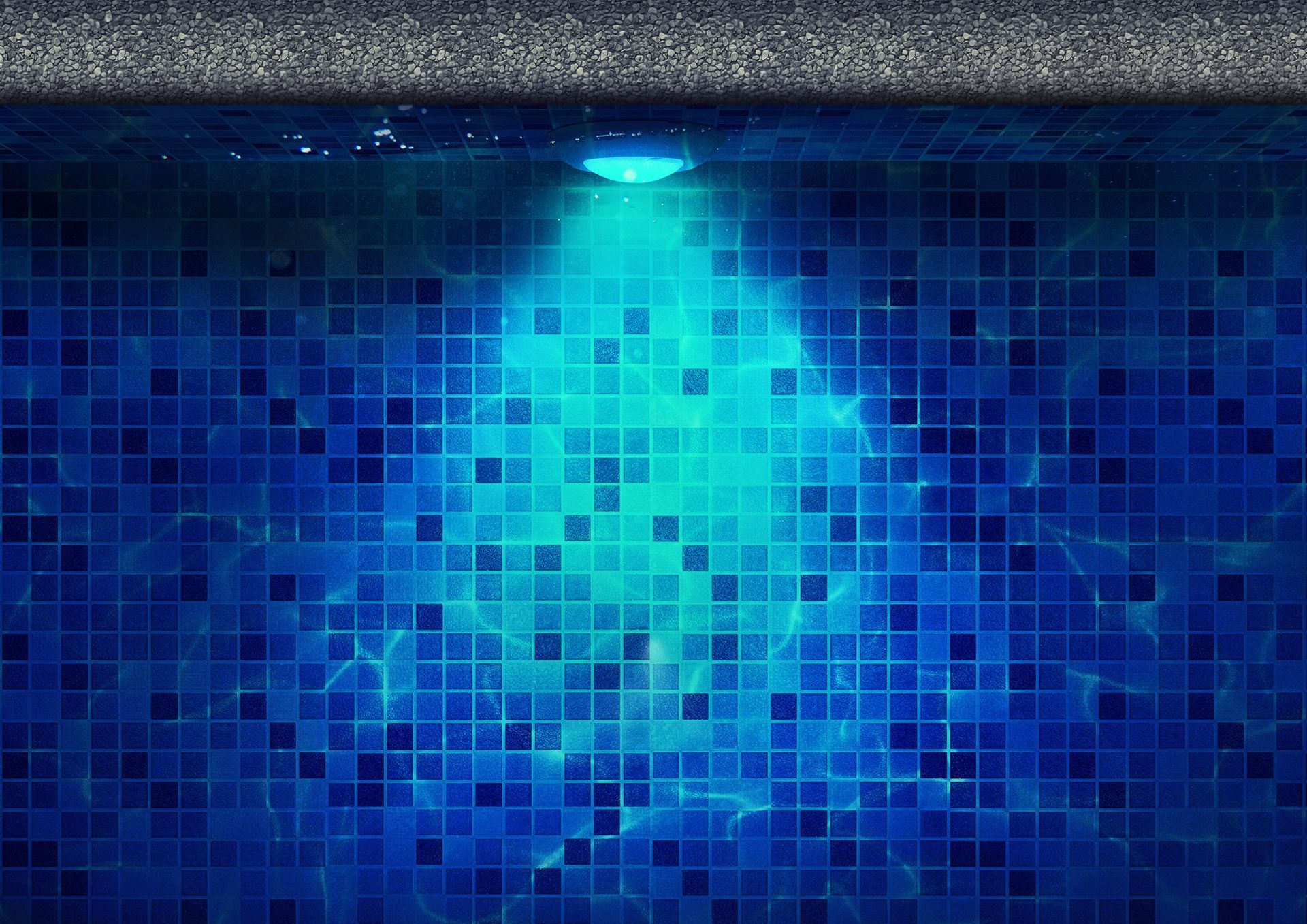 A blue tiled wall in a swimming pool with a light shining on it.