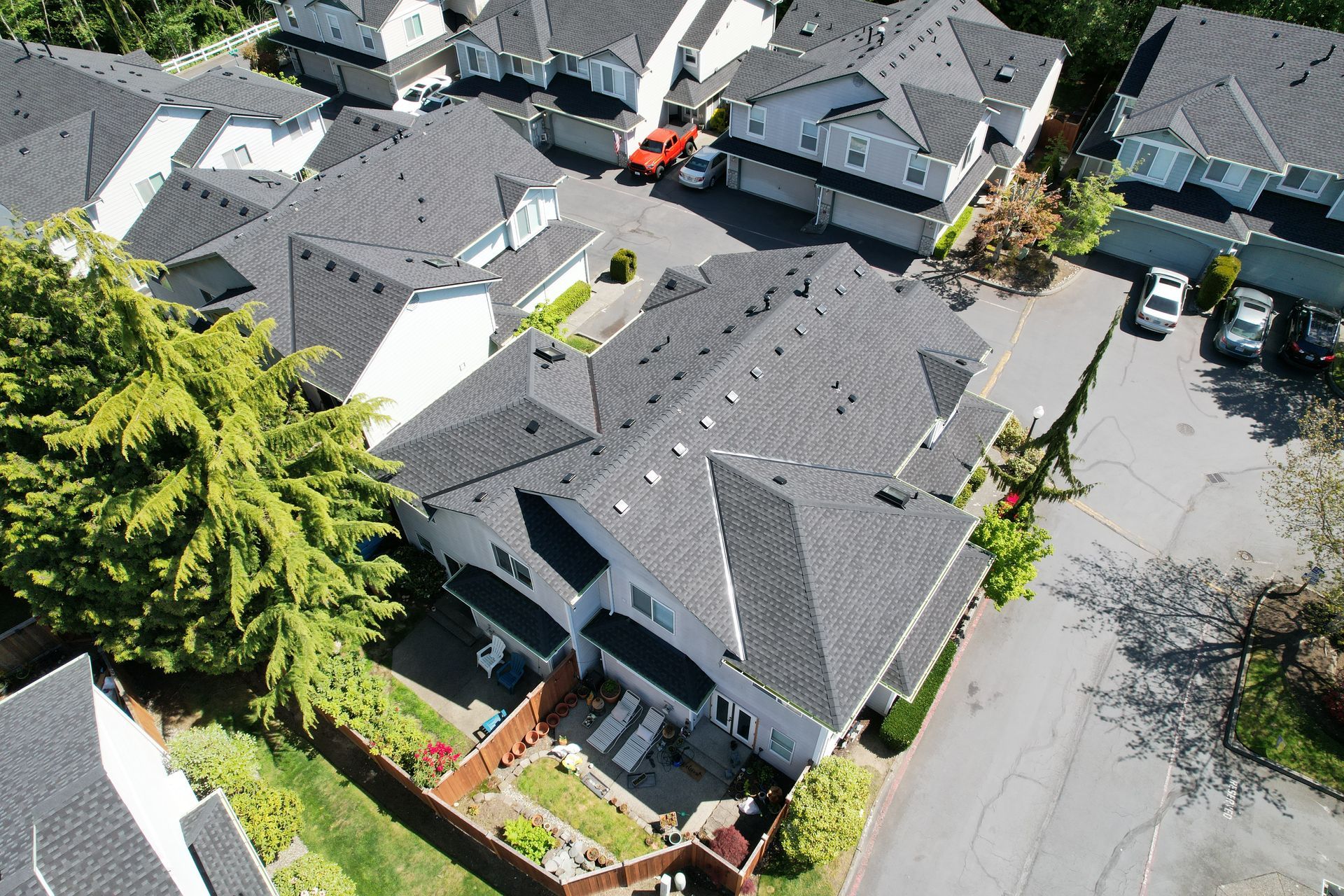 An aerial view of a row of houses with black roofs taken by Riverside Roofing