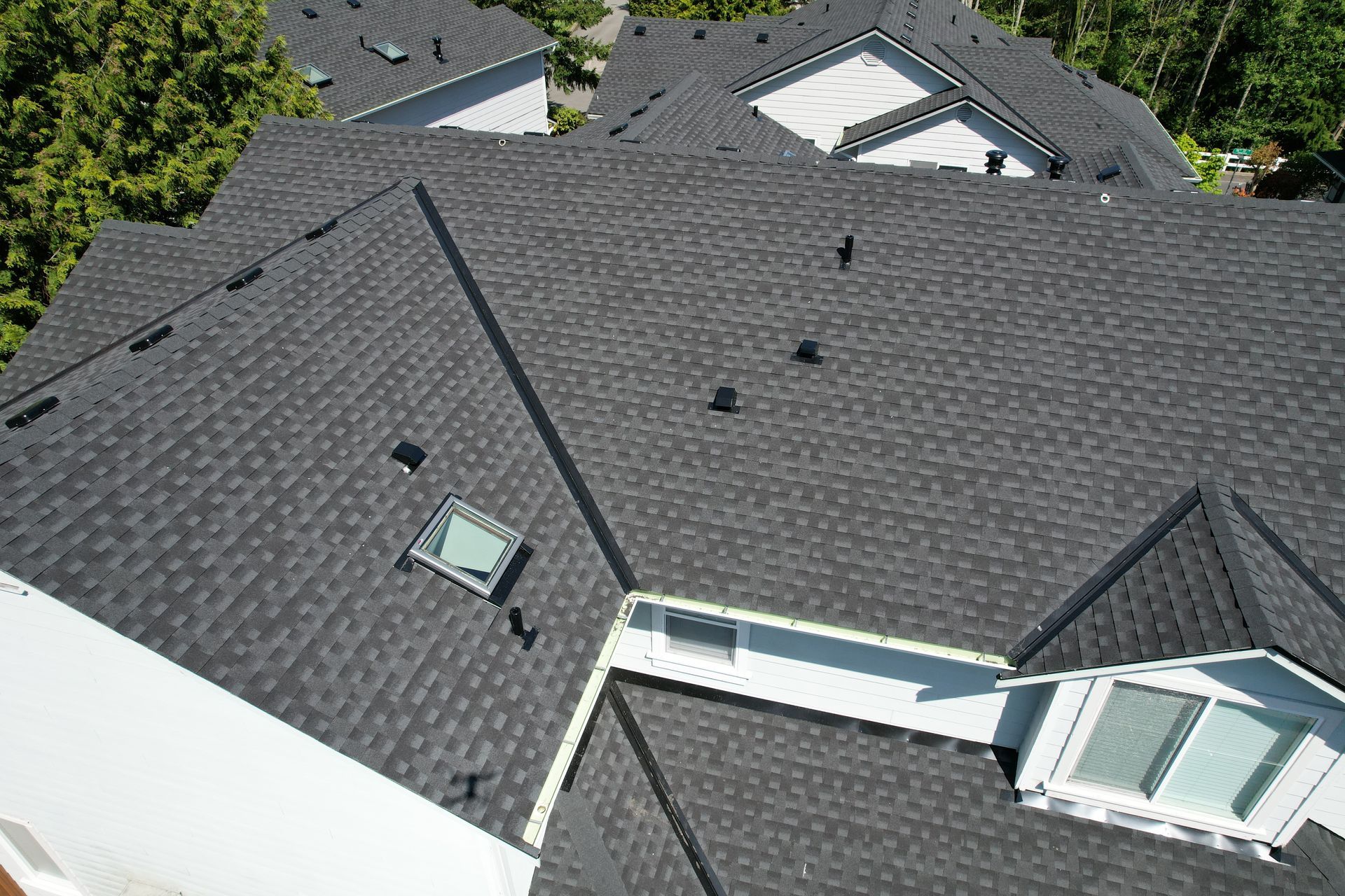 An aerial view of a roof with a lot of windows and skylights taken by Riverside Roofing