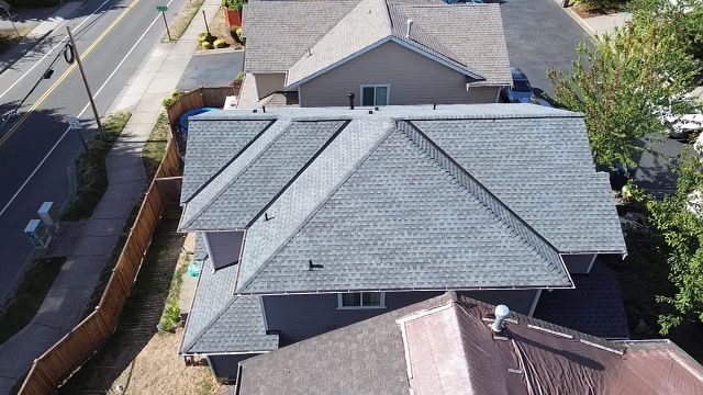 An aerial view of a house with a new roof taken by Riverside Roofing