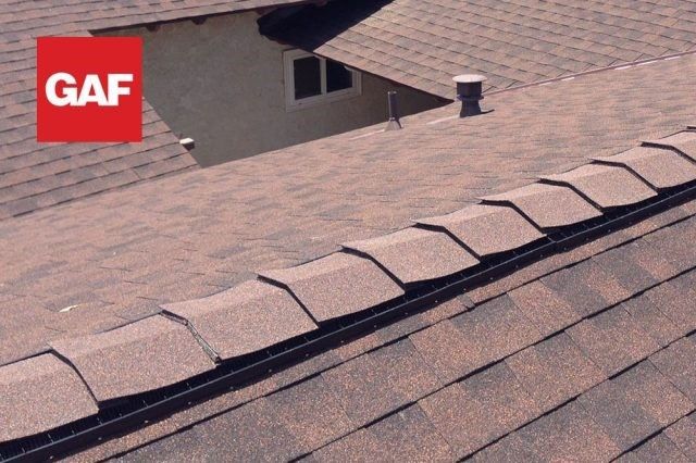 A roof with the word gaf on it shows the top most shingle or cap layer used over a roof vent