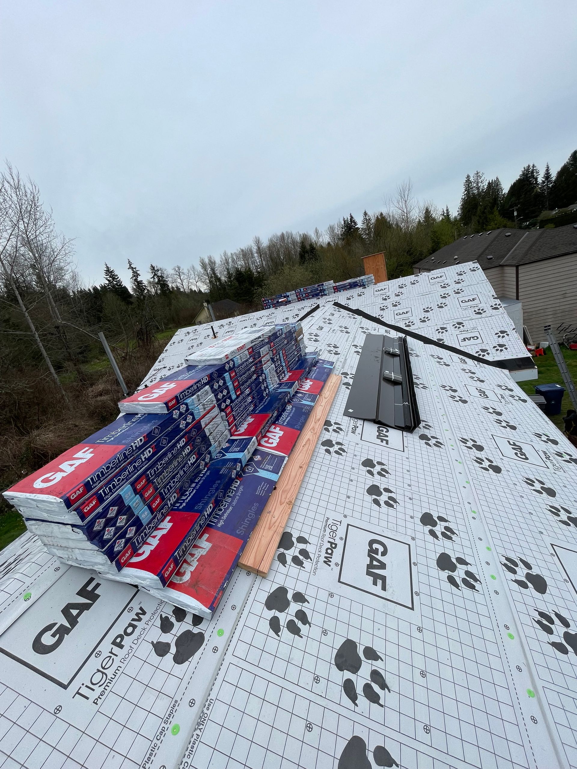 A roof with a lot of roofing material on it taken by Riverside Roofing