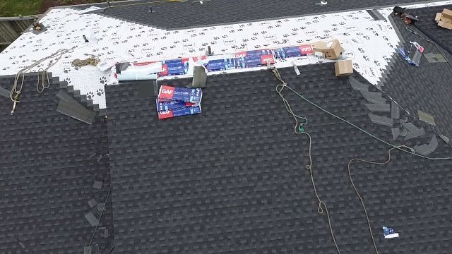 An aerial view of a roof with shingles being installed taken by Riverside Roofing