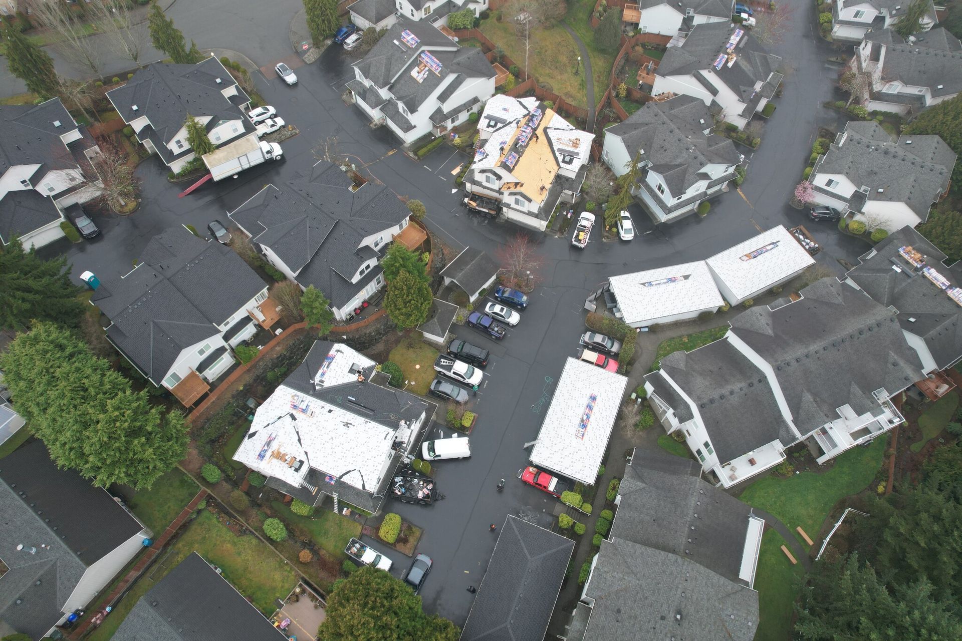 An aerial view of a residential area with a lot of houses taken by Riverside Roofing
