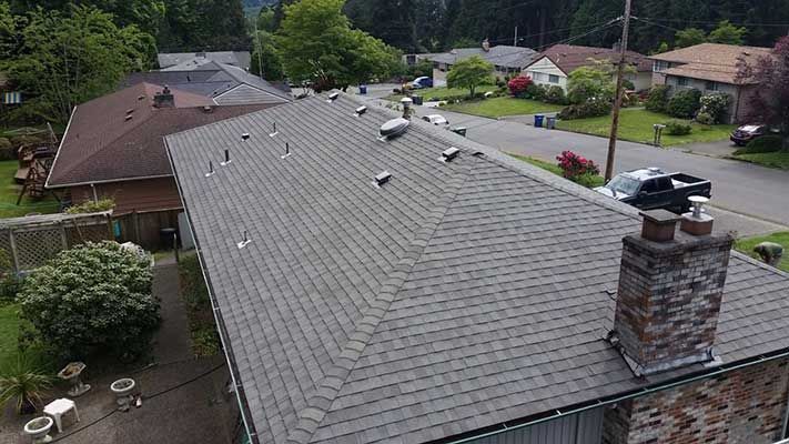 An aerial view of a house with a roof and chimney.