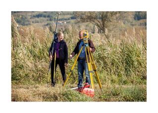 Surveyors setting up in a field