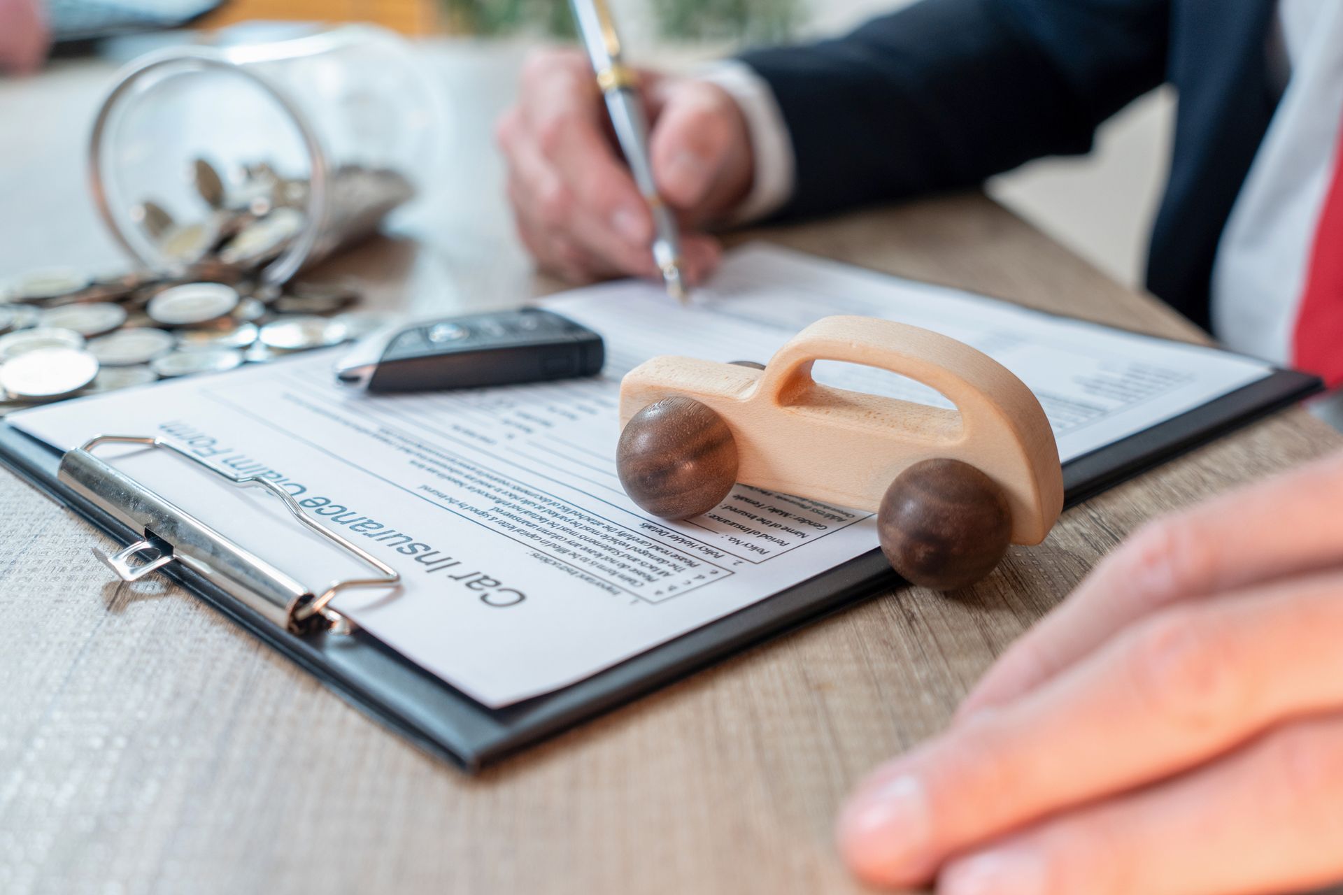 A man is signing a contract for his car insurance.