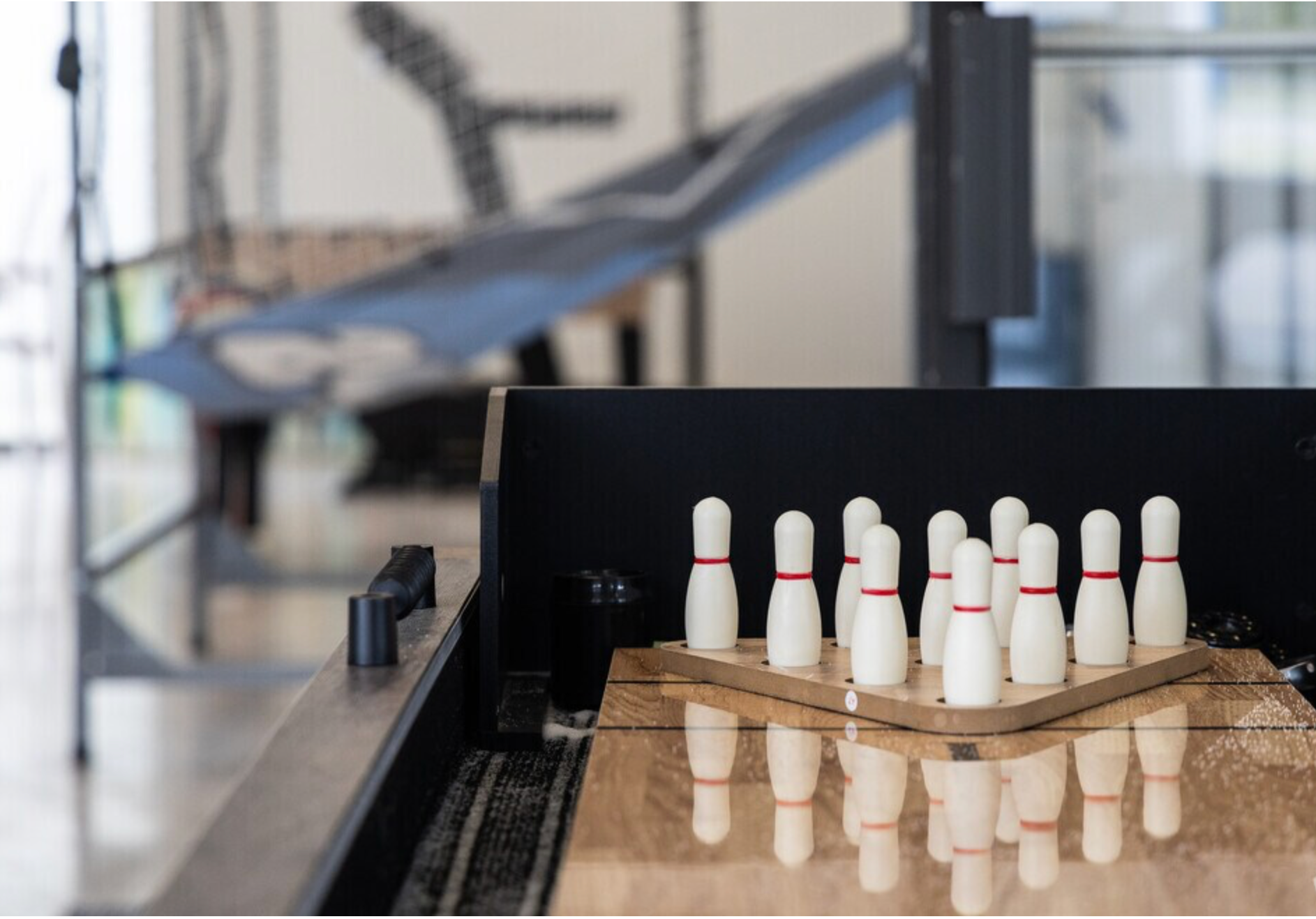 A bowling alley with a bunch of pins on it