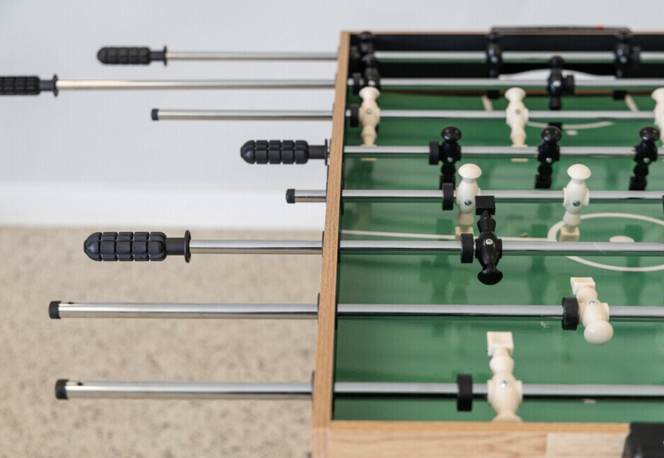 A foosball table is sitting on a carpeted floor