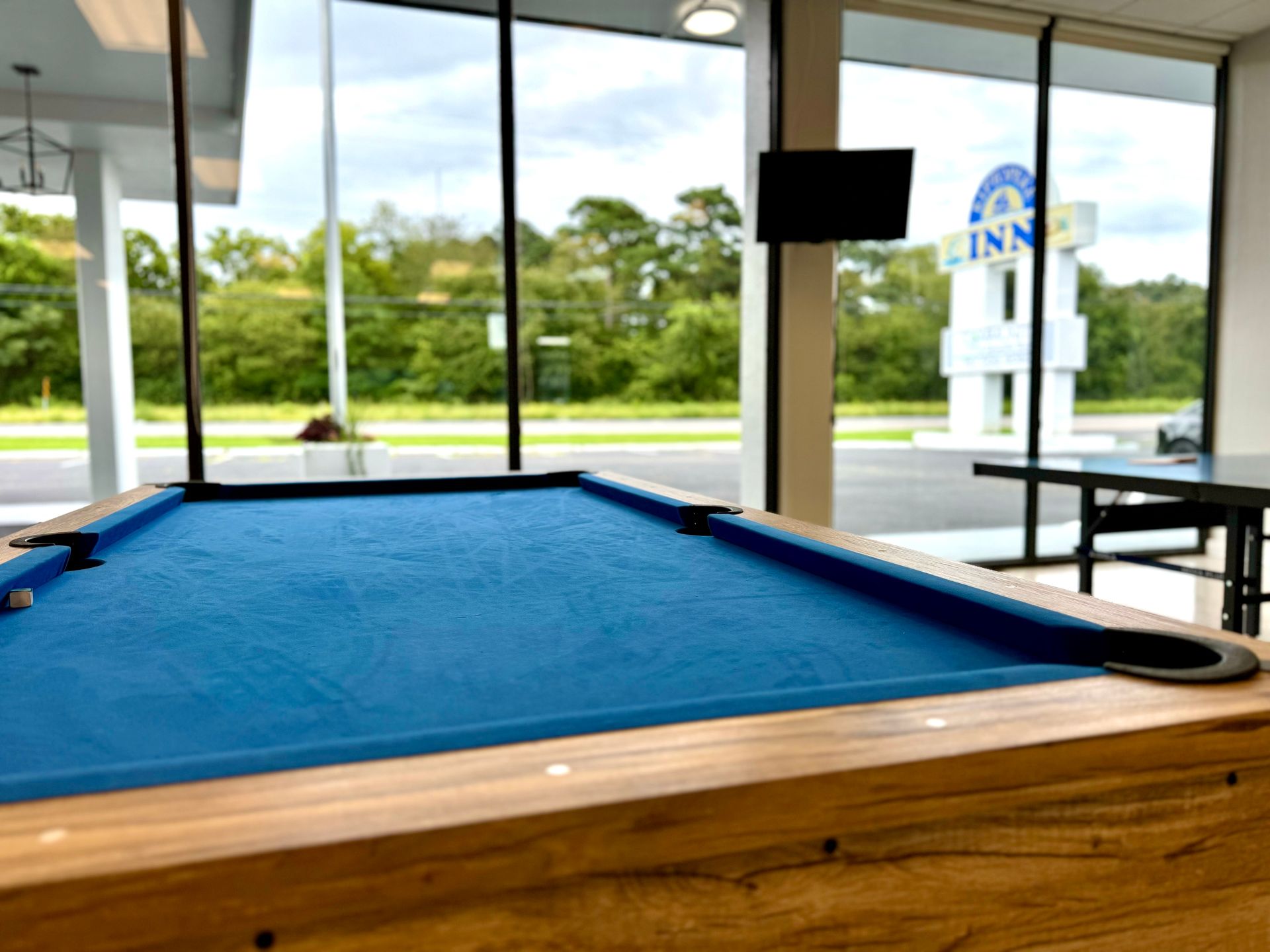 A pool table in a room with a sign that says inn on it