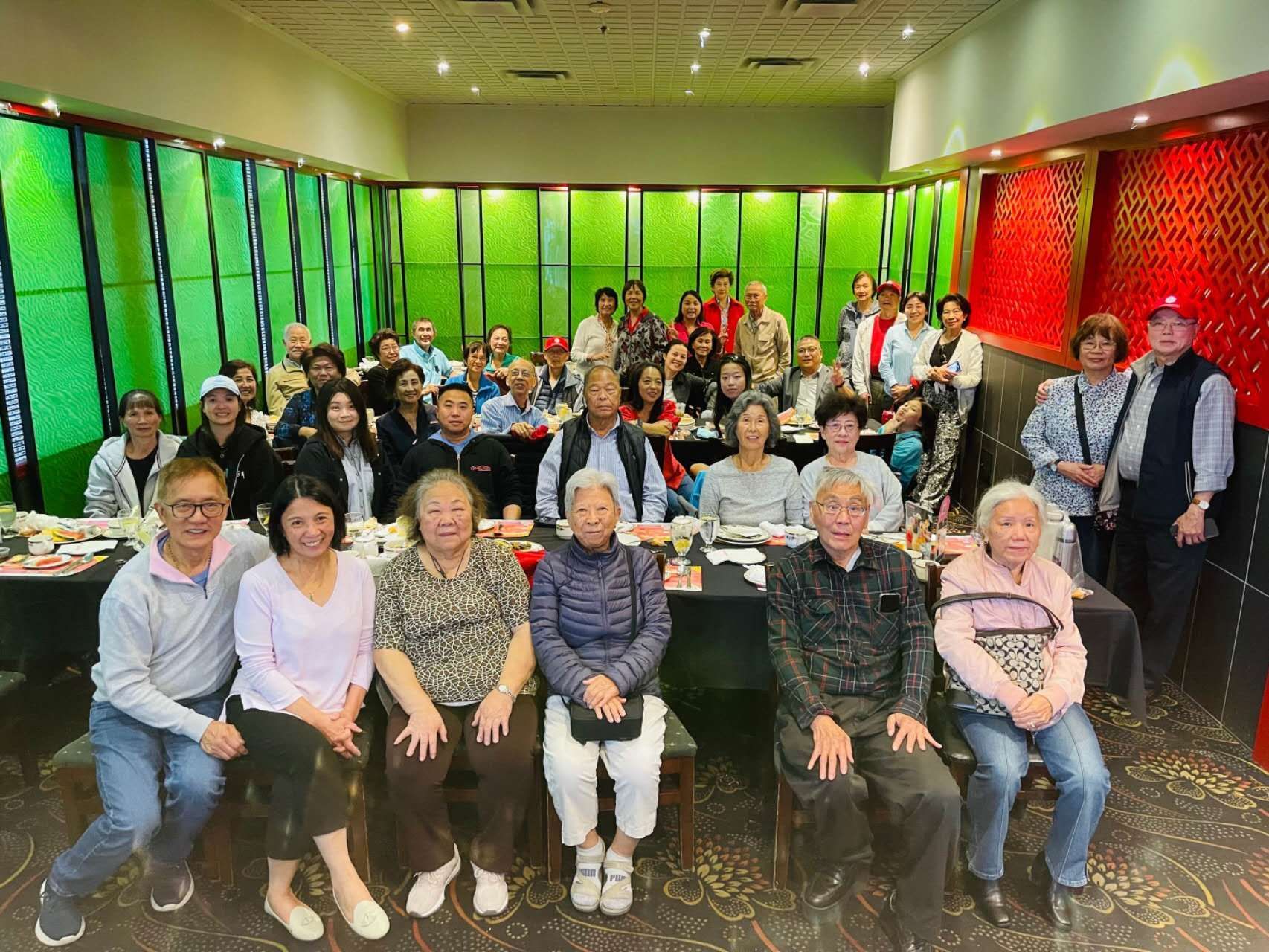 A group of people are posing for a picture in a room.