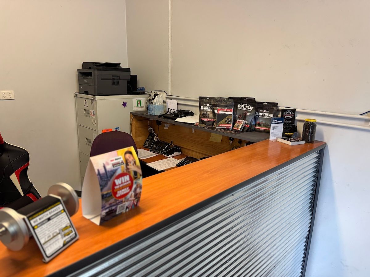 A Ford Truck Is Parked In A Grassy Field — All Automotive Services In Bundaberg East, QLD