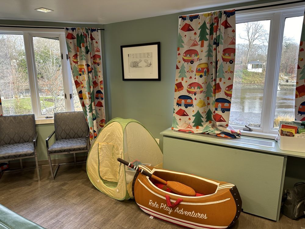 A room with a canoe and a tent in it.