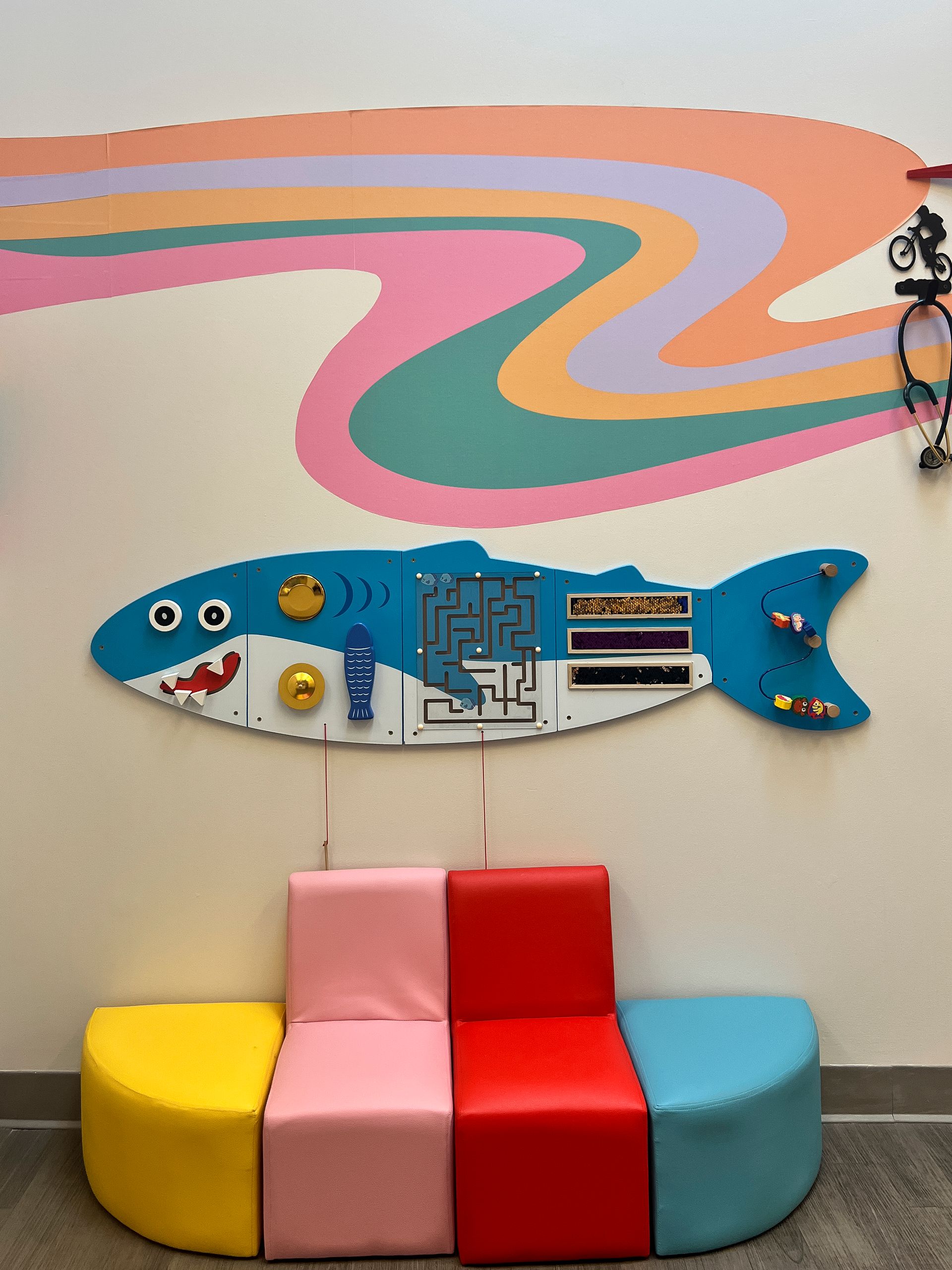 A wall with a fish on it and a maze on it