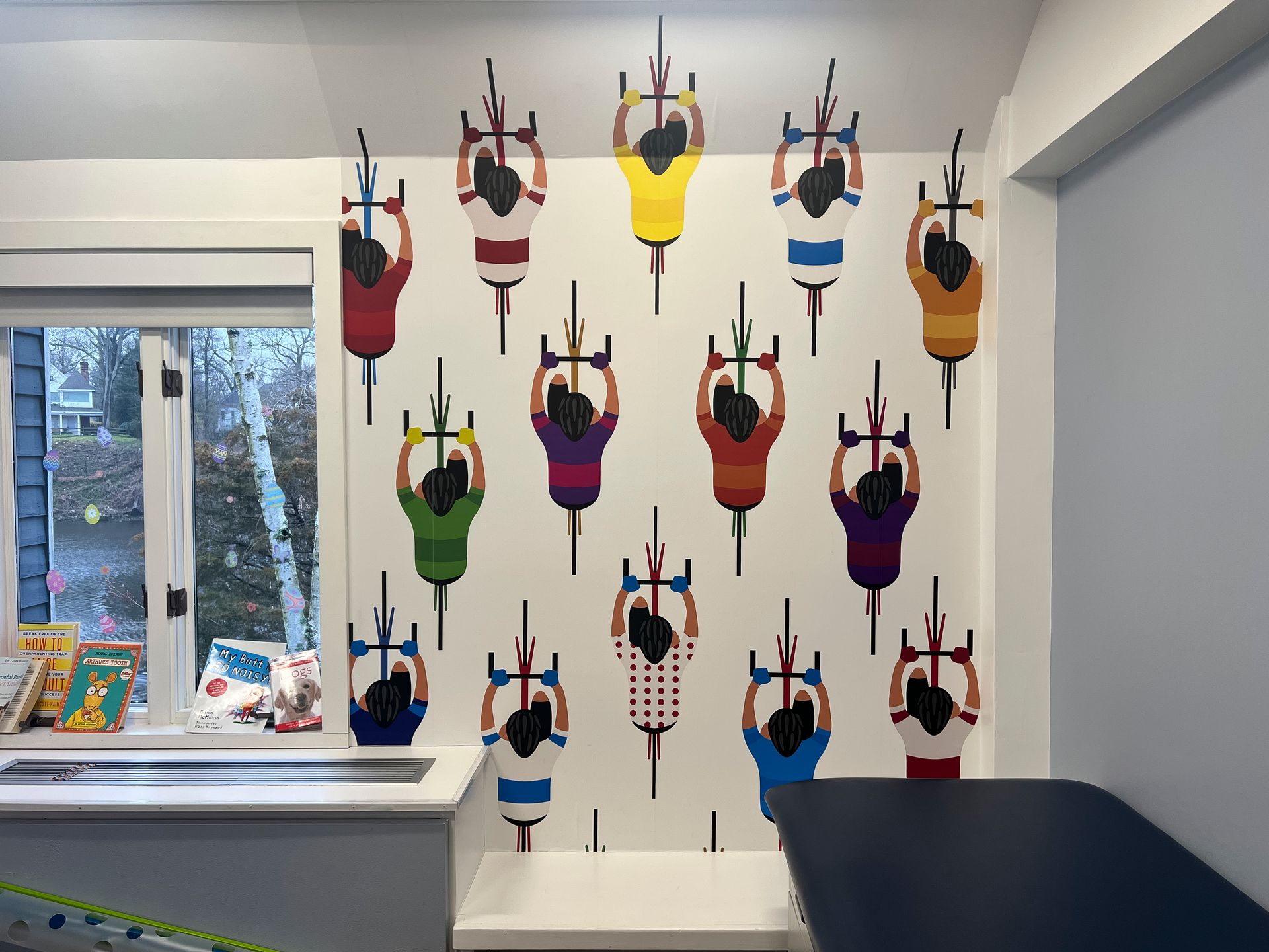 A wall with a painting of people riding bicycles on it.